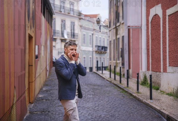 Man musician in a blue blazer and white sweater playing blues on a harmonica with eyes closed, standing outdoors in city street