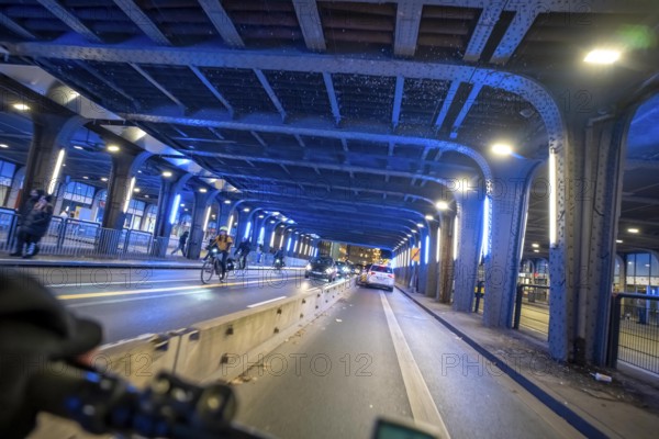 Cycling in the city, in the dark, in the evening, cycling underpass at the main train station, in downtown Essen, North Rhine-Westphalia, Germany