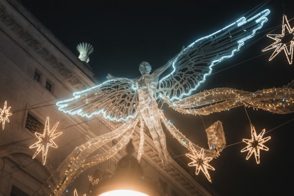 Shining angel and stars form festive Christmas decoration, New Year's Eve London, United Kingdom
