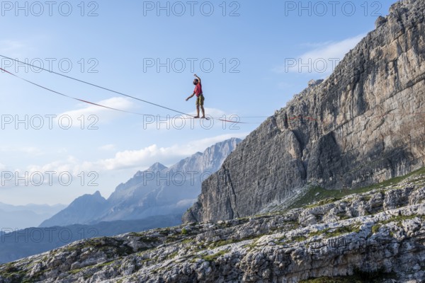 Slackliner in the mountains, mountain peaks of the Brenta Mountains, at Refugio Francis Fox Tuckett, Brenta, Brenta-Adamello Natural Park, Trentino, Italy