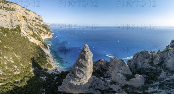 Picturesque rocky coast, cliffs with L'Aguglia pinnacle, blue sea and Cala Goloritzé beach, aerial view, Golfo di Orosei, Baunei, Sardinia, Italy