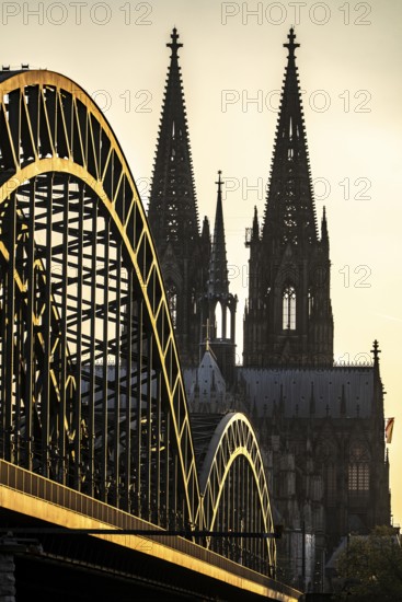 Silhouettes of the cathedral in late sunlight, view of Cologne Cathedral and the Hohenzollern railway bridge over the Rhine near Cologne, North Rhine-Westphalia, Germany