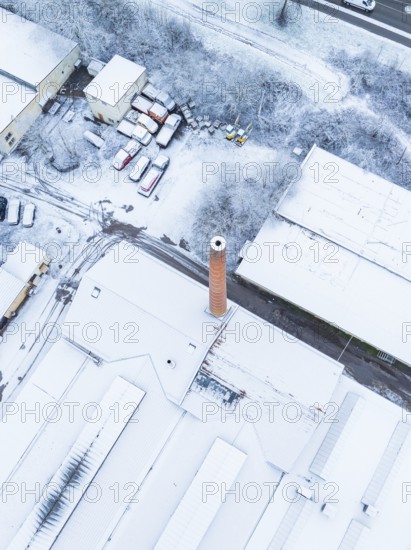 Factory district with striking chimney, completely covered in snow, Nagold, Black Forest, Germany