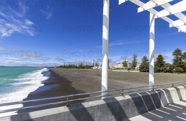 Overlooking the sandy shore of Hawke Bay, this image captures Napier's distinctive art deco architecture lining the vibrant seafront promenade