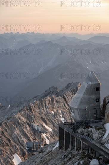 Mountain station of the Tyrolean Zugspitze railway at the summit of the Zugspitze, at sunset, Wetterstein Mountains, Northern Limestone Alps, Bavaria, Germany