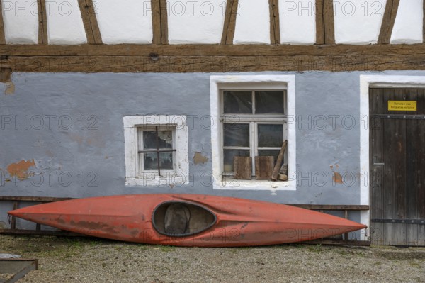 Parked kayak at an old farmhouse, Egloffstein, Upper Franconia, Bavaria, Germany