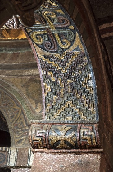 Arched vault with the seal of Lalibela carved in stone and coloured geometric ornaments, monolithic rock church of Biete Maryam, UNESCO World Heritage Site Lalibela, Ethiopia