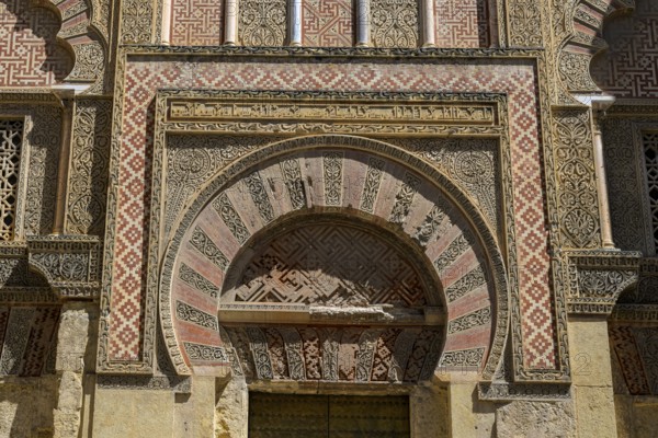 Córdoba Cathedral Mosque, Mezquita-Cathedral, Impressive arch of decorated sandstone with red and white patterns, Magnificent archway with complex red and beige patterns, Moorish style, Cordoba, Andalusia, Spain