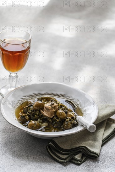 Traditional Chakapuli, a Georgian dish of stewed lamb with tarragon, coriander, green onion, and green tkemali, often paired with dry white or amber wine