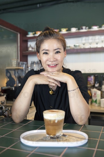 Korean woman, 47, in her café, Yeosu, Jeollanam-do Province, South Korea