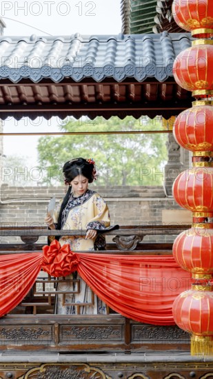 A woman in traditional Qing Dynasty attire stands gracefully on a decorated balcony in Pingyao, China, surrounded by vibrant red lanterns that evoke a festive atmosphere