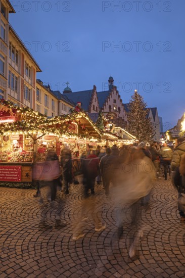 December 22, 2025, Frankfurt Christmas Market on Roemerberg at twilight. Traditional wooden stalls and festive lights shine in the historic square, Frankfurt, Hesse, Germany