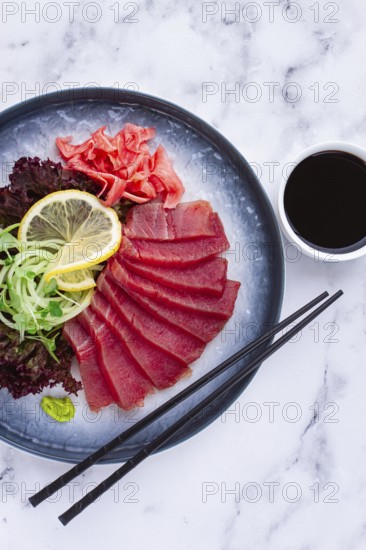 Tuna sashimi, with side dish, on a marble table, homemade, no people