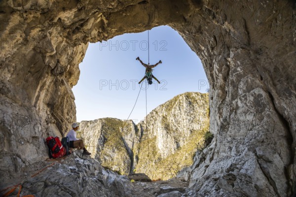 A man is engaging in mountaineering and rappelling activities at Eagleâ€™s Nest, Monterrey, Mexico. The stunning natural rock formations provide an exhilarating backdrop