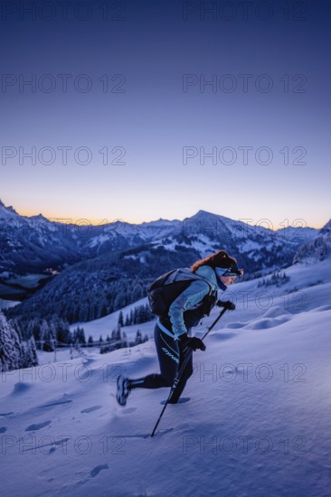 Hiking in the snow in the snow-covered winder landscape in the Alps at Neunerköpfle in the Tannheimer Tal in Tyrol, Austria