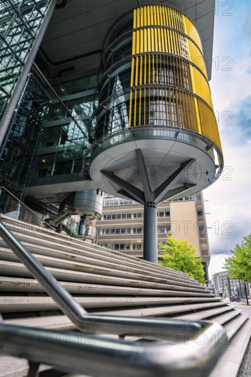 Modern building design with glass façade and yellow blinds in an urban environment, Berlin, Germany