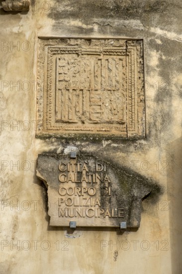 Weathered stone slab on a wall with an ancient inscription in Italian, Galatina, Apulia, Italy
