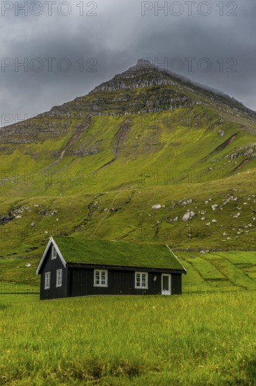Lonely grass roofed house in Gjogv, Estuyroy, Faroe islands, Denmark