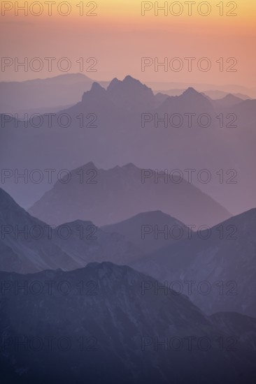 Silhouettes of mountains at sunset, view from the summit of the Zugspitze, Wetterstein Mountains, Northern Limestone Alps, Bavaria, Germany