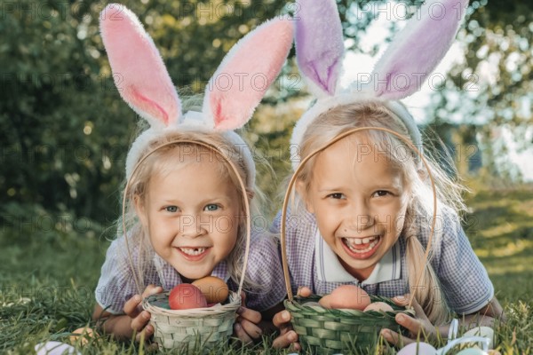 Two smiling children wearing bunny ears enjoy an Easter egg hunt in a sunny garden, holding baskets filled with colorful eggs. The scene captures joy, playfulness, and festive spirit