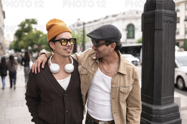 A joyful colombian gay couple enjoying a casual city walk. Both are wearing sunglasses and showcasing happiness and connection against an urban backdrop of architecture and vehicles