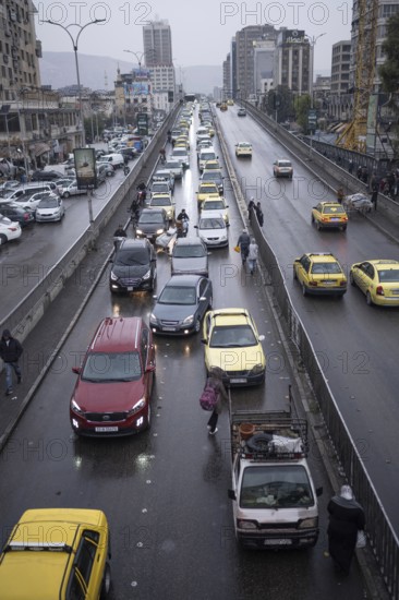 Damascus, Syria. December 6th 2025. A wet and busy with traffic Al Thawra street in downtown district of the Syrian capital near the traditional Old City of Damascus, Syria