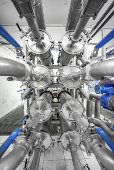 Symmetrical arrangement of metal pipes and valves in an industrial environment, ENCW Netze Calw waterworks, Calw, Black Forest, Germany