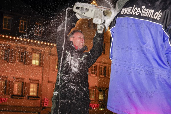 An ice sculpture is being created: ice carving street action as part of the long shopping night in the city center of Reutlingen, Baden-Württemberg, Germany, for editorial use only