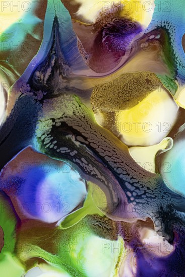 This abstract image showcases vibrant ink blends with rich textures flowing over multiple colored backgrounds including blue, green, yellow, and purple