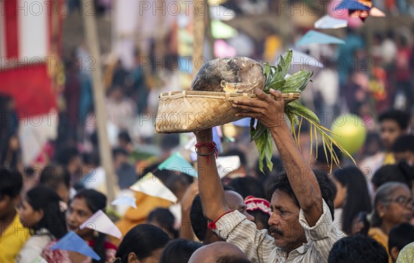 Hindu devotees gather on the banks of the Brahmaputra River to offer prayers to the Sun God on the occasion of Chhath Puja, in Guwahati, India on 27 October 2025