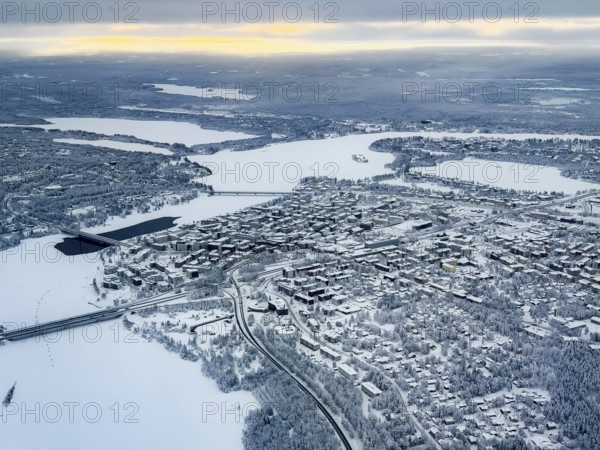 View of the snowy town of Rovaniemi with the Kemijoki river, in winter, aerial view, Finland