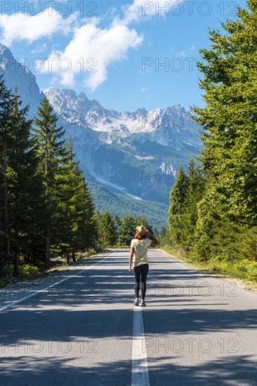 A young girl walking on the road in the Valbona valley, Theth national park, Albanian Alps, Valbona Albania