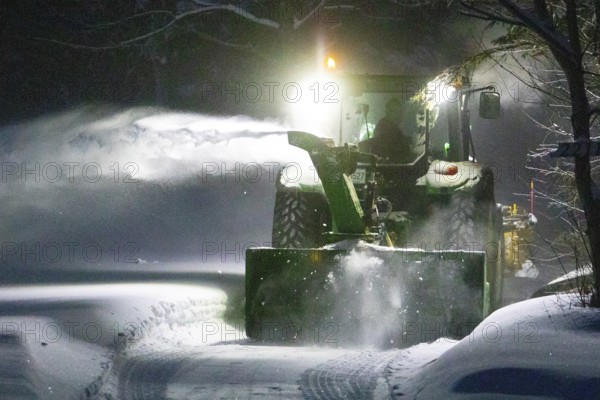 Heavy machinery clearing snow from a property entrance, Region of la Mauricie, Province of Quebec, Canada
