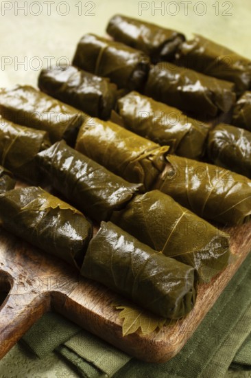 Dolma, minced meat with rice, in grape leaves, minced meat rolls, on a chopping board, top view, no people