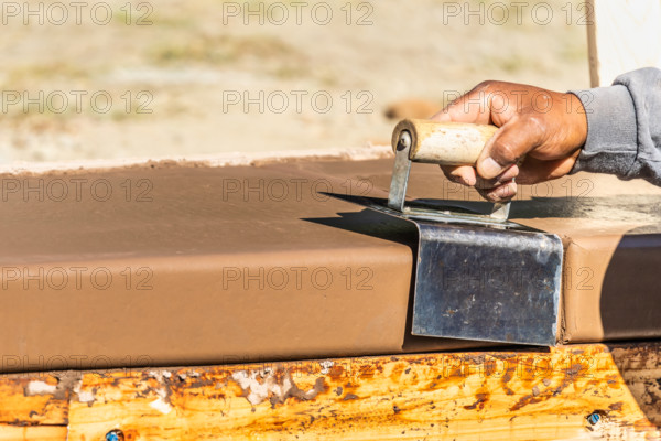 Construction Worker Using Stainless Steel Edger On Wet Cement Forming Coping Around New Pool