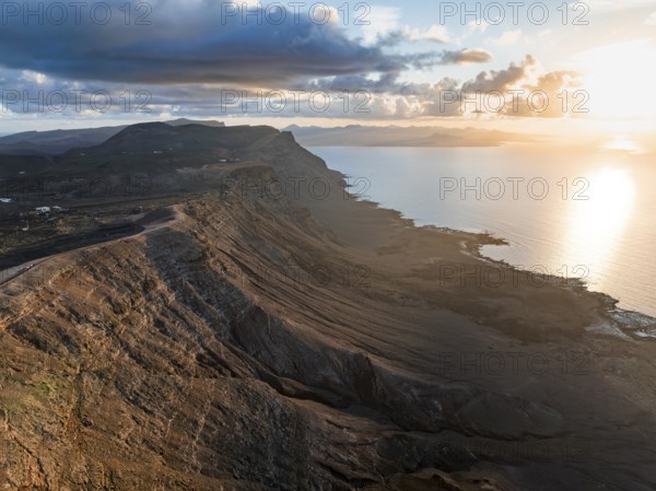 Cliffs by the sea in evening light, steep cliffs on the coast near the Mirador del Porrito, aerial view, at sunset, Lanzarote, Canary Islands, Spain