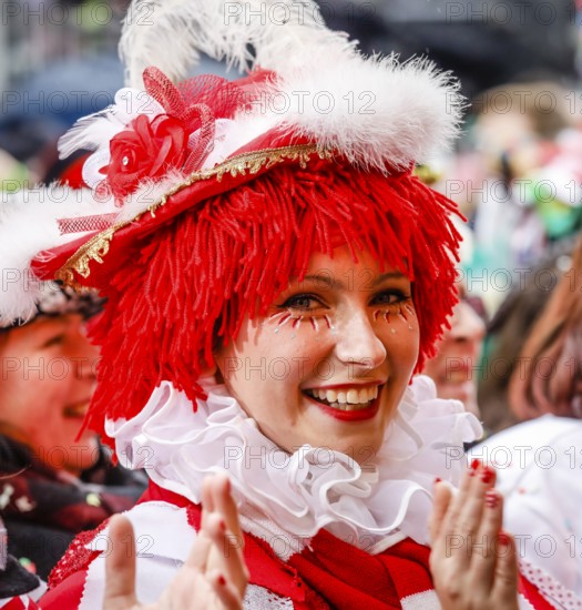Colourfully costumed carnivalists celebrate carnival in Cologne, on Weiberfastnacht the street carnival is traditionally opened on the Alter Markt, which then reaches its climax on Rosenmontag, Cologne, Rhineland, North Rhine-Westphalia, Germany
