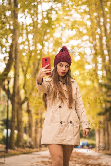 Portrait of a beautiful woman in autumn together in a forest in nature on a video call