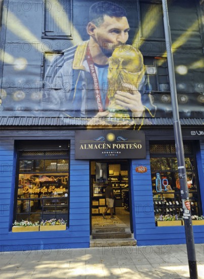Shop front with a large mural of footballer Lionel Messi with trophy, La Boca neighbourhood, Buenos Aires, Argentina