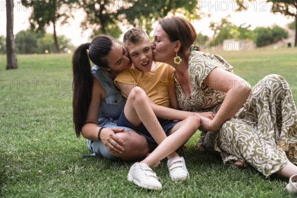 A family enjoying a sunny day in the park, showcasing love and connection with a disabled boy with cerebral palsy