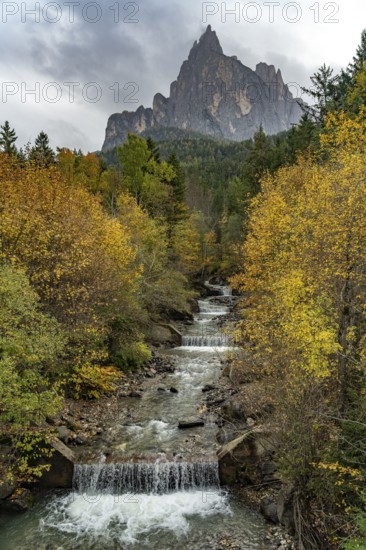 Autumn at the Schwarzgriesbach stream and the Schlern mountain in Seis am Schlern, South Tyrol, Italy