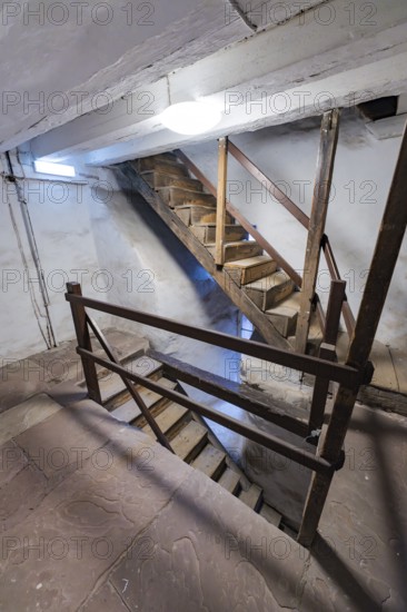 Interior view with wooden staircase and stony floor in a historic building, Prison Museum, Der Lange, Calw, Black Forest, Germany