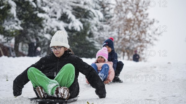 In Gaziantep, Turkey, on December 31, 2025, children and families enjoy winter activities as they play on snow-covered areas and slide on icy hills, creating a lively atmosphere across the city during the final day of the year, Gaziantep, Gaziantep, Turkey