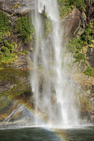Rainbow over waterfall, Milford Sound, Fiordland National Park, South Island, Southland, New Zealand