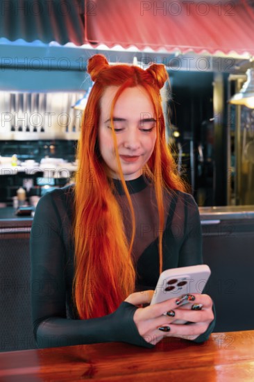 A young woman with vibrant red hair checks her phone in a lively market ambiance, blending modern technology with a colorful and busy background