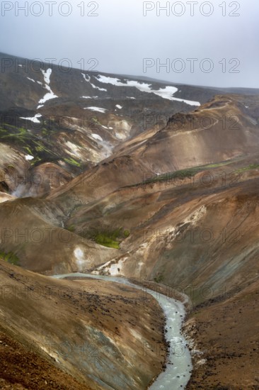 Steaming streams between colourful rhyolite mountains in the Hveradalir geothermal area, Kerlingarfjöll, Icelandic Highlands, Iceland