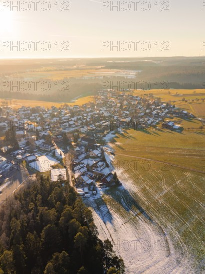 View of a wintry village with fields and forests in the sunset light, Neuweiler, district of Calw, Black Forest, Germany