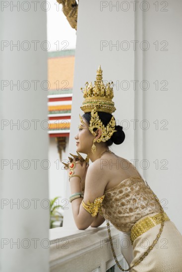 Thai traditionally and festively dressed young woman, Wat Pho, Bangkok, Thailand