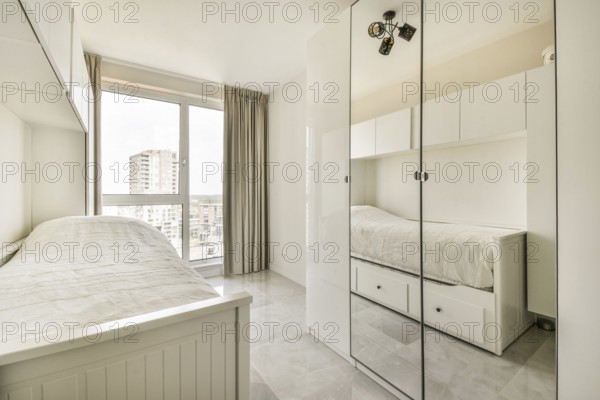 Bright, minimalist bedroom featuring a single bed, mirrored wardrobe and large window with cityscape view. The decor is sleek and contemporary with neutral tones