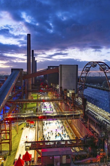 The ice rink at the Zollverein coking plant, UNESCO World Heritage Zollverein Coal Mine Industrial Complex, 150 metres long, against the backdrop of the coke ovens, formerly the largest coking plant in the world, Essen, North Rhine-Westphalia, Germany